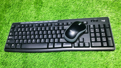 Black keyboard and mouse set on a green grass background