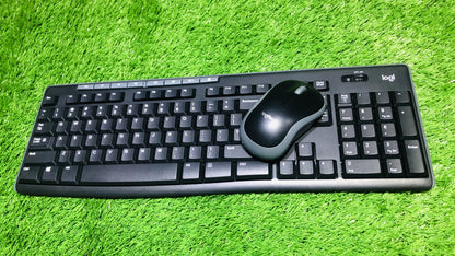 Black keyboard and mouse set on a green grass background