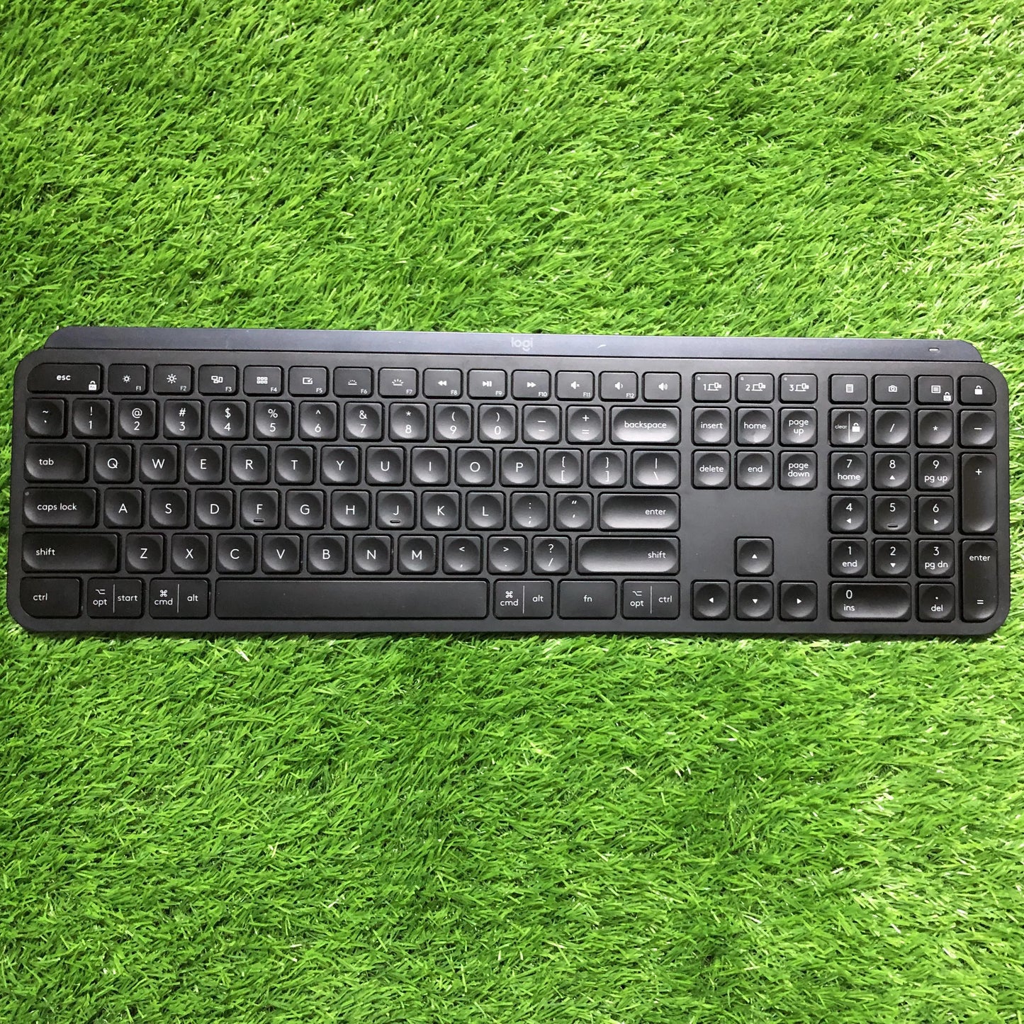 Black keyboard and mouse set on green grass