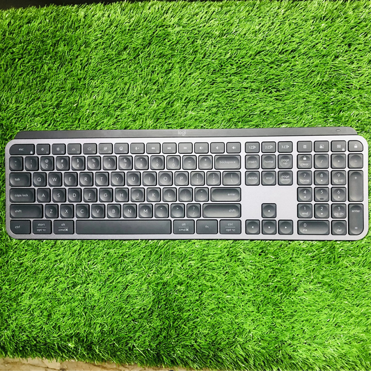 Keyboard and mouse set on a green grass-like surface