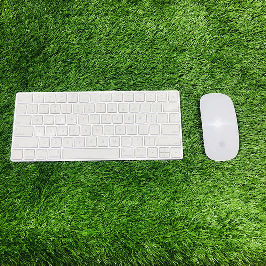 White keyboard and mouse set on a green grass-like surface